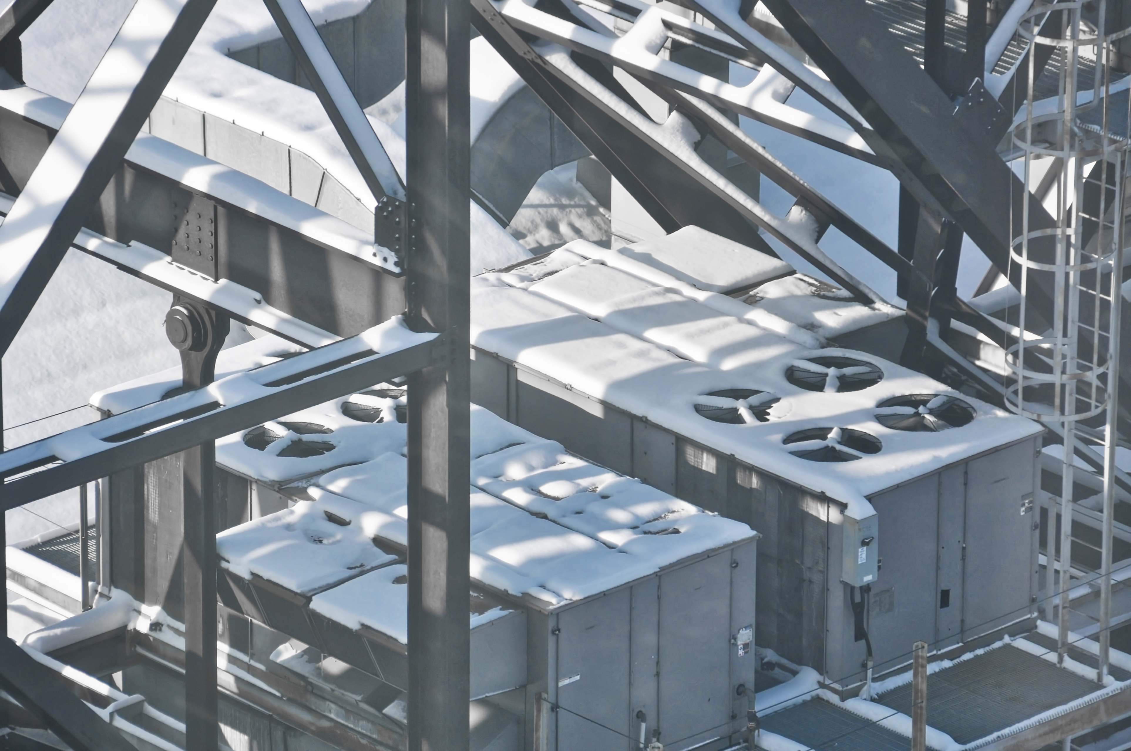 During winter, on the rooftop machinery, snow piles up.